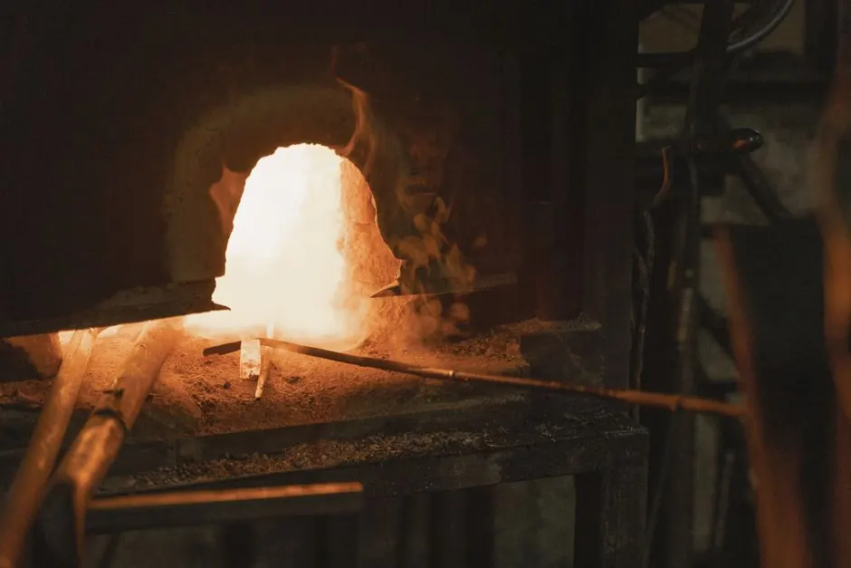 Image of a vibrant blacksmith forge with tools and a glowing furnace, showcasing intense heat and craftsmanship.